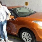 Deepak Wadhwa poses with his Maruti Suzuki Baleno car